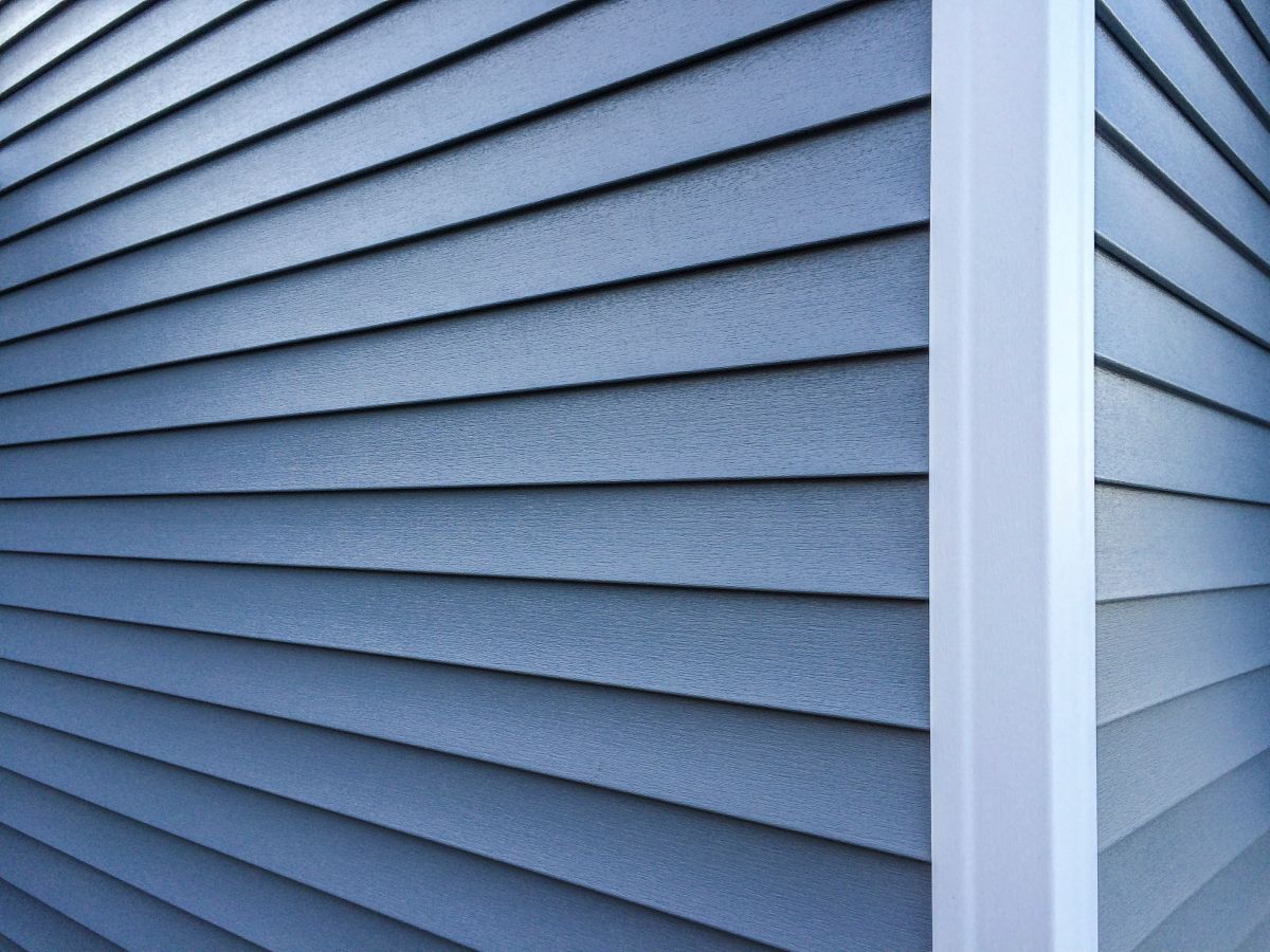 Blue vinyl siding with white trim on the outside wall of a new home, Wayzata, MN