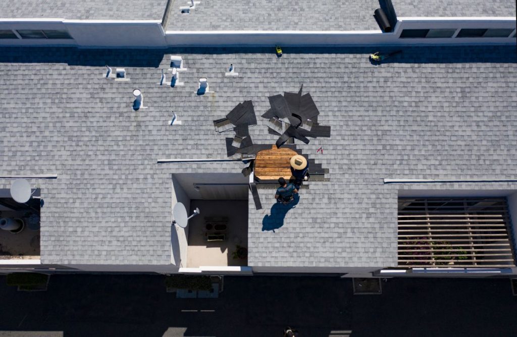 aerial view of roofers fixing a shingle roof, Wayzata, MN